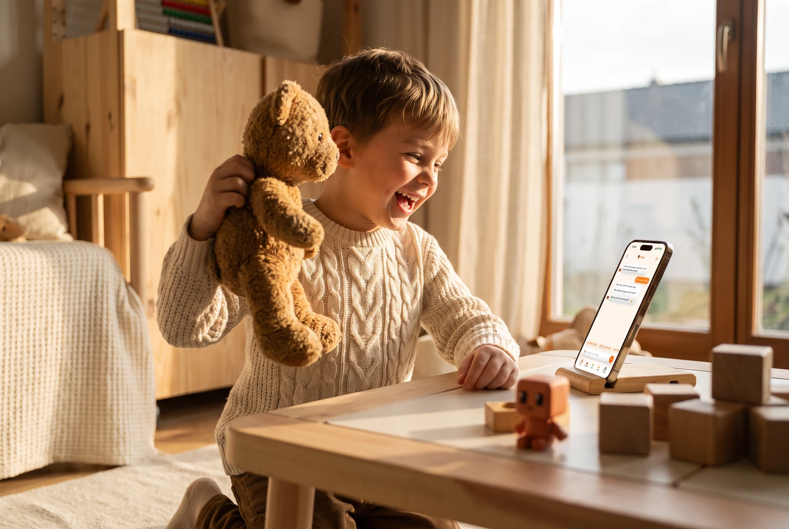 A boy holding up his teddy bear, laughing at the storybook Yuna made about it